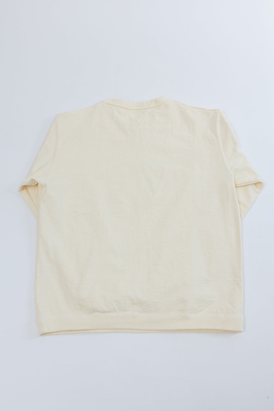 Back view flat lay of a cream long-sleeve cotton t-shirt.