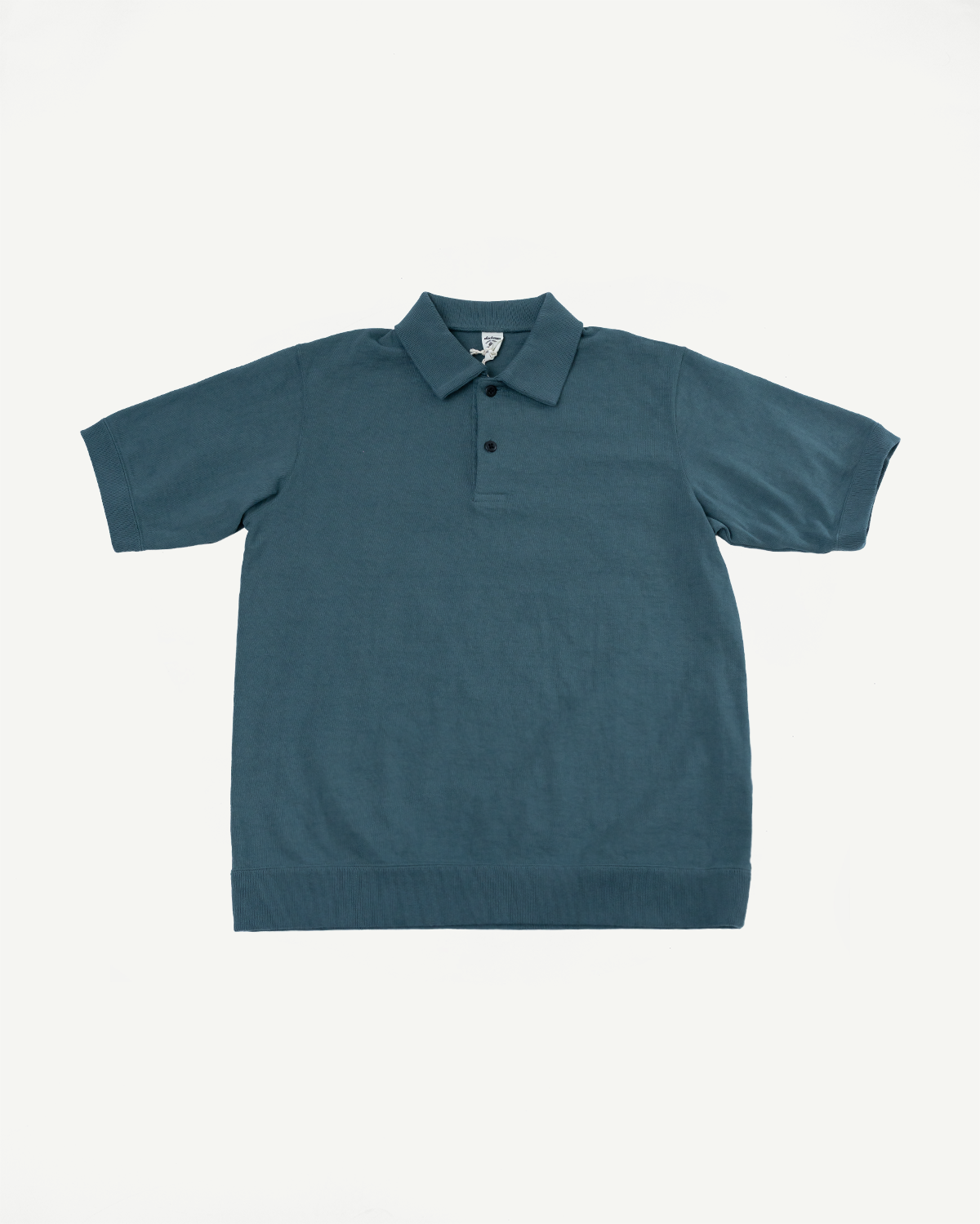 Teal corded polo shirt front flat lay, short sleeves, ribbed collar & hem, two-button placket, tag visible