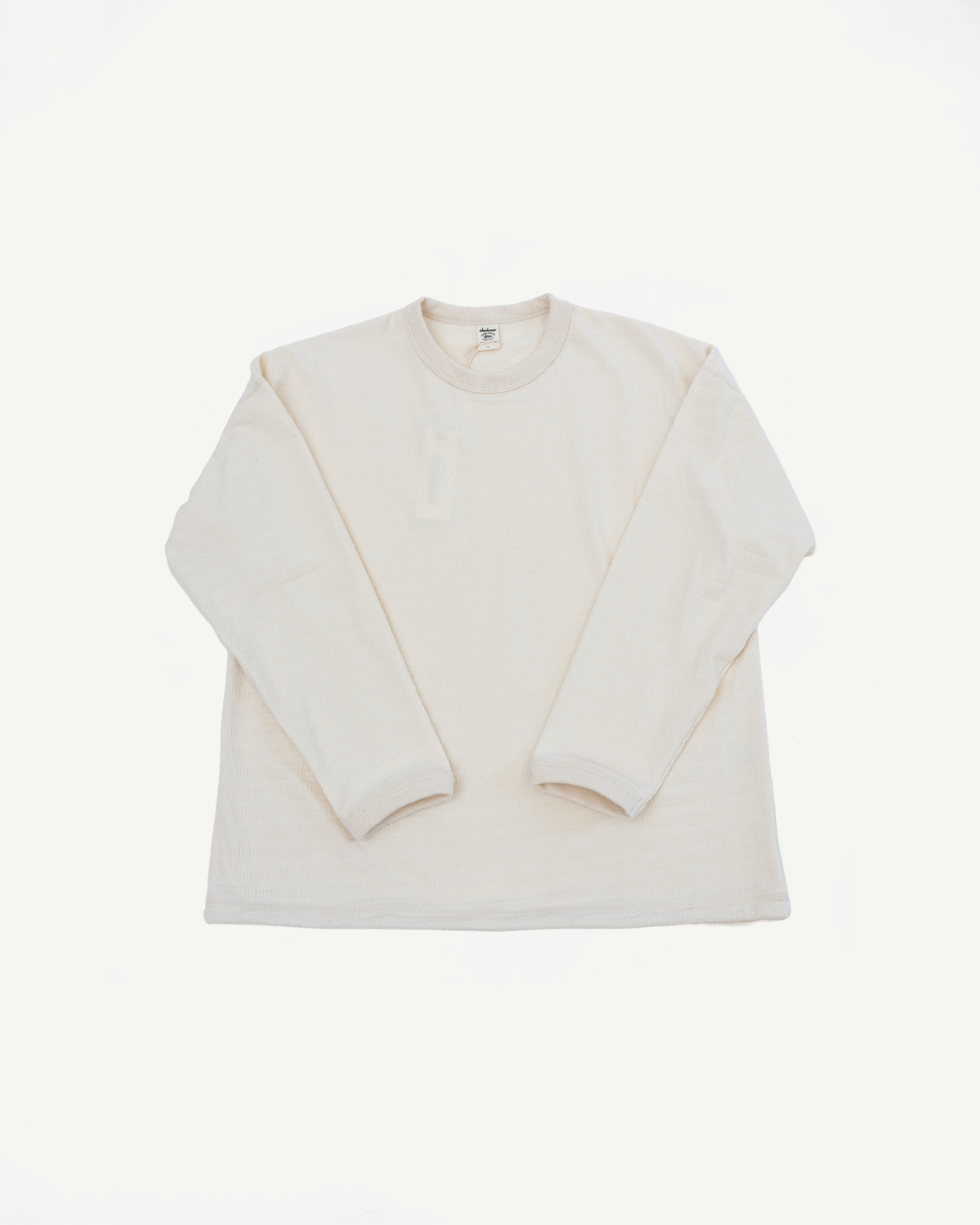 Front flat lay of an ecru long sleeve crewneck t-shirt, showing full garment and fabric texture.