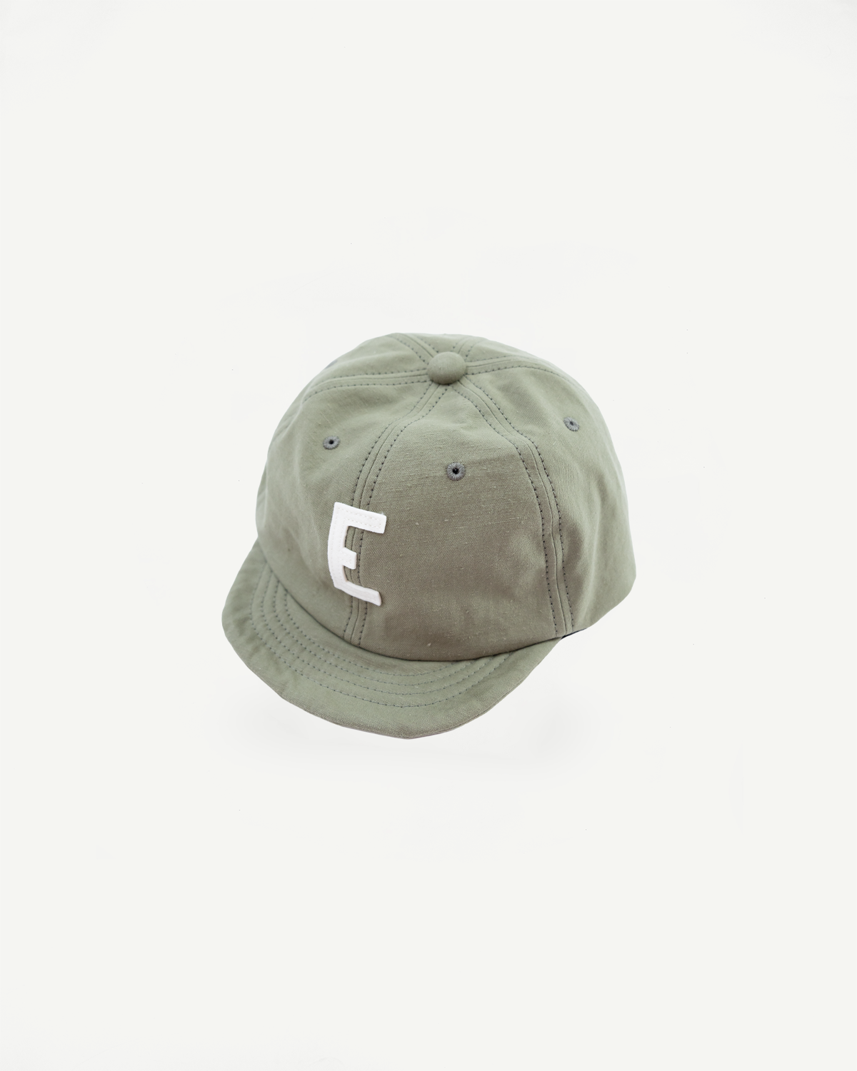 Green cap with a white logo on a white background