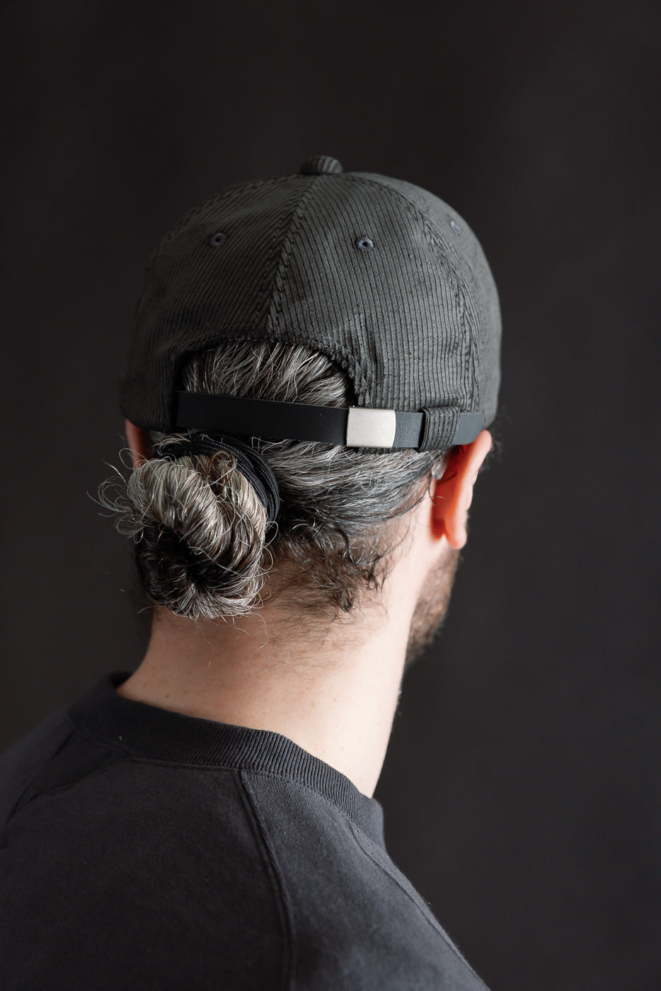 Close-up of back of Jackman corduroy baseball cap in faded black on male model, 5'9
