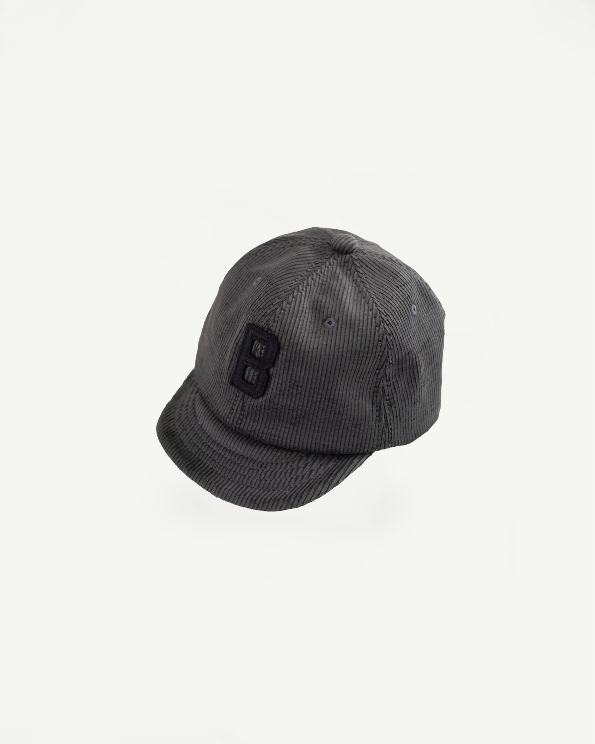 Front flat lay of Jackman black corduroy cap with embroidered B, curved brim and textured fabric