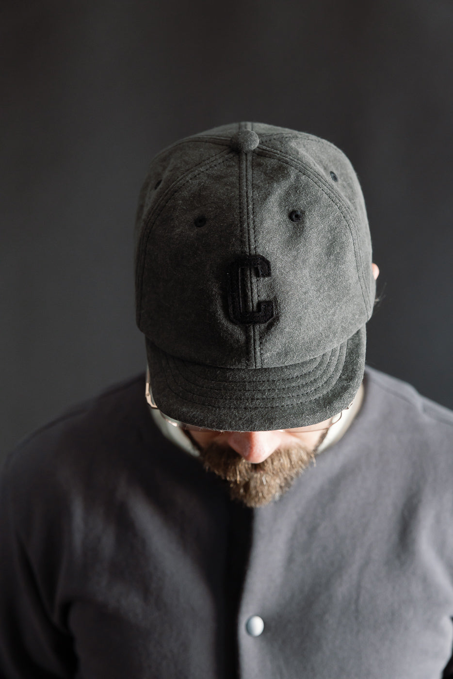 Close-up front view of black Jackman JM6575 Sumi BB Cap on male model, 5'9