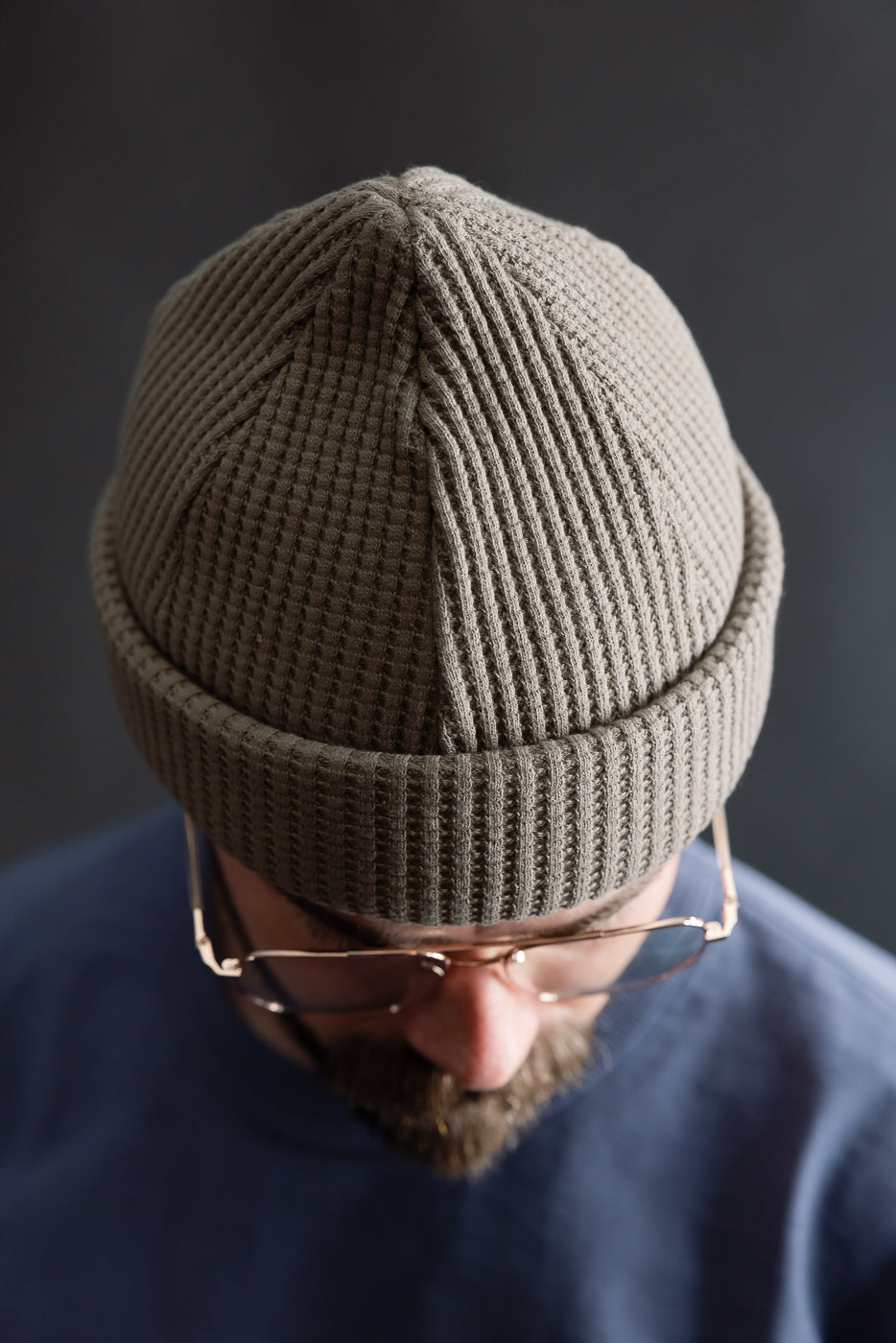 Close-up top view of sepia waffle knit cap on male model, 5'9