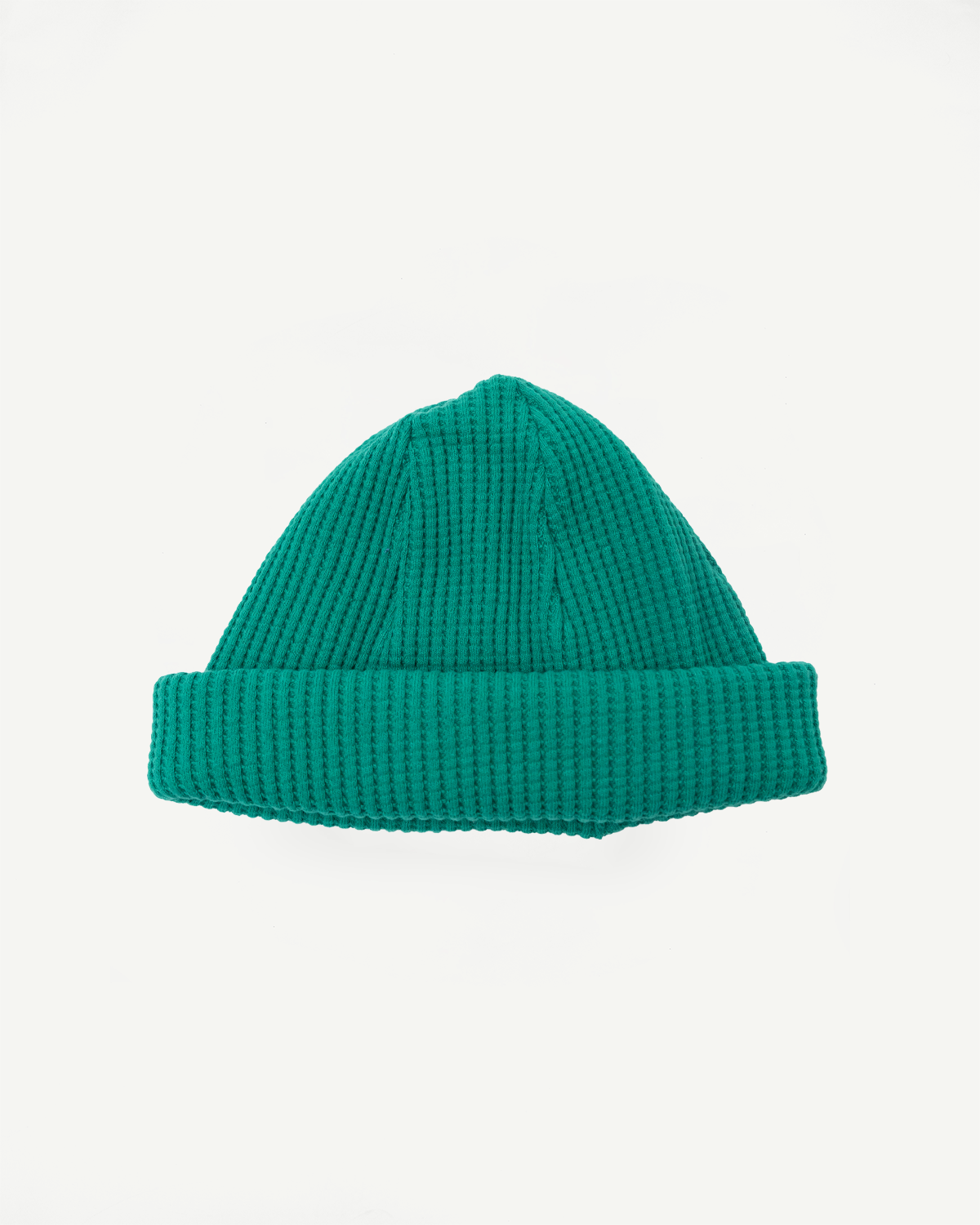 Green knit beanie on a white background
