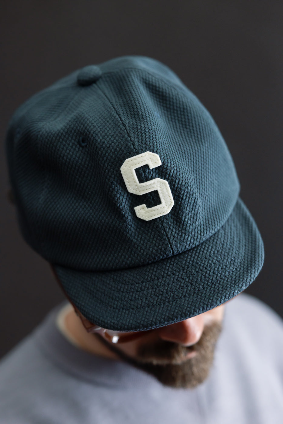 JM6623 - Sashiko BB Cap S - 280 Iron Navy features a textured weave with a white S patch on the front, exemplifying Japanese craftsmanship with its unique sashiko fabric.