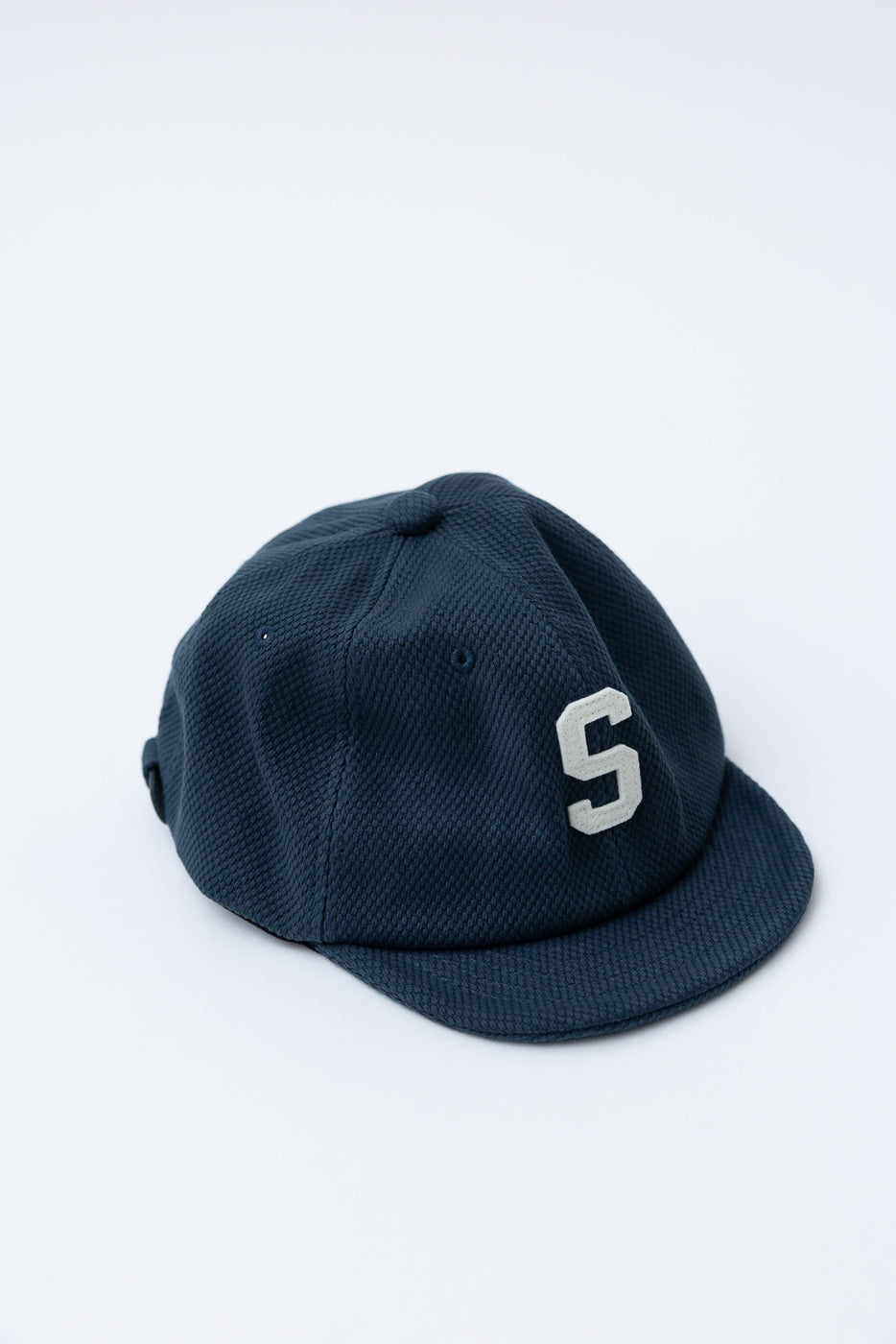 JM6623 - Sashiko BB Cap S in Iron Navy, featuring a textured sashiko fabric and a prominent white S patch, embodies Japanese heritage with unique craftsmanship.