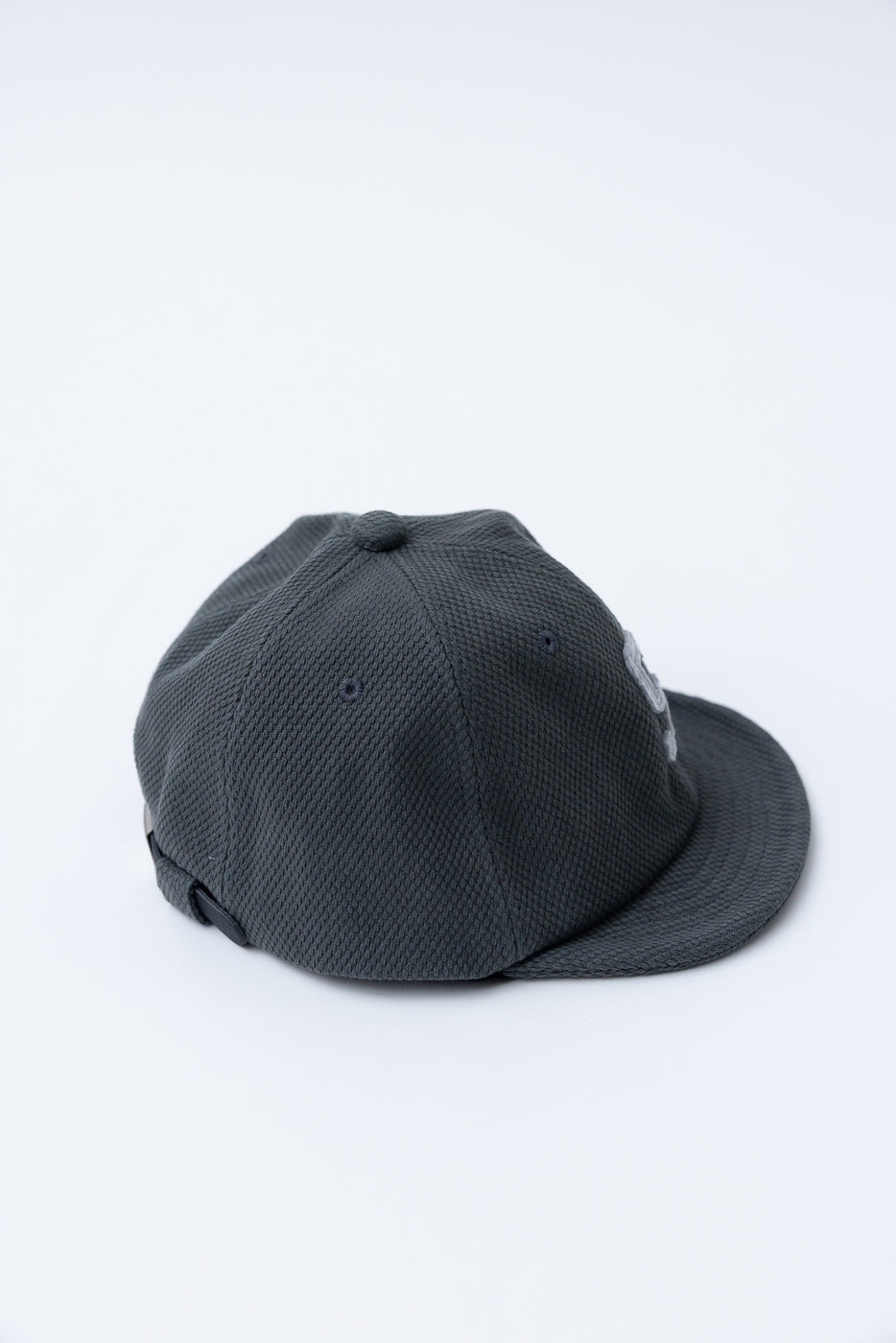 JM6623 - Sashiko BB Cap S - 333 Falcon Gray, a dark charcoal-gray snapback cap in textured sashiko fabric, crafted in Japan, displayed on a white background.