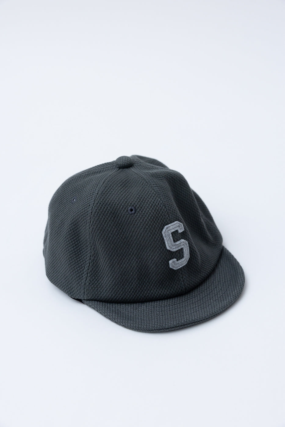 JM6623 - Sashiko BB Cap S - 333 Falcon Gray: A dark gray cap with a textured sashiko fabric and raised S emblem, reflecting authentic Japanese craftsmanship.