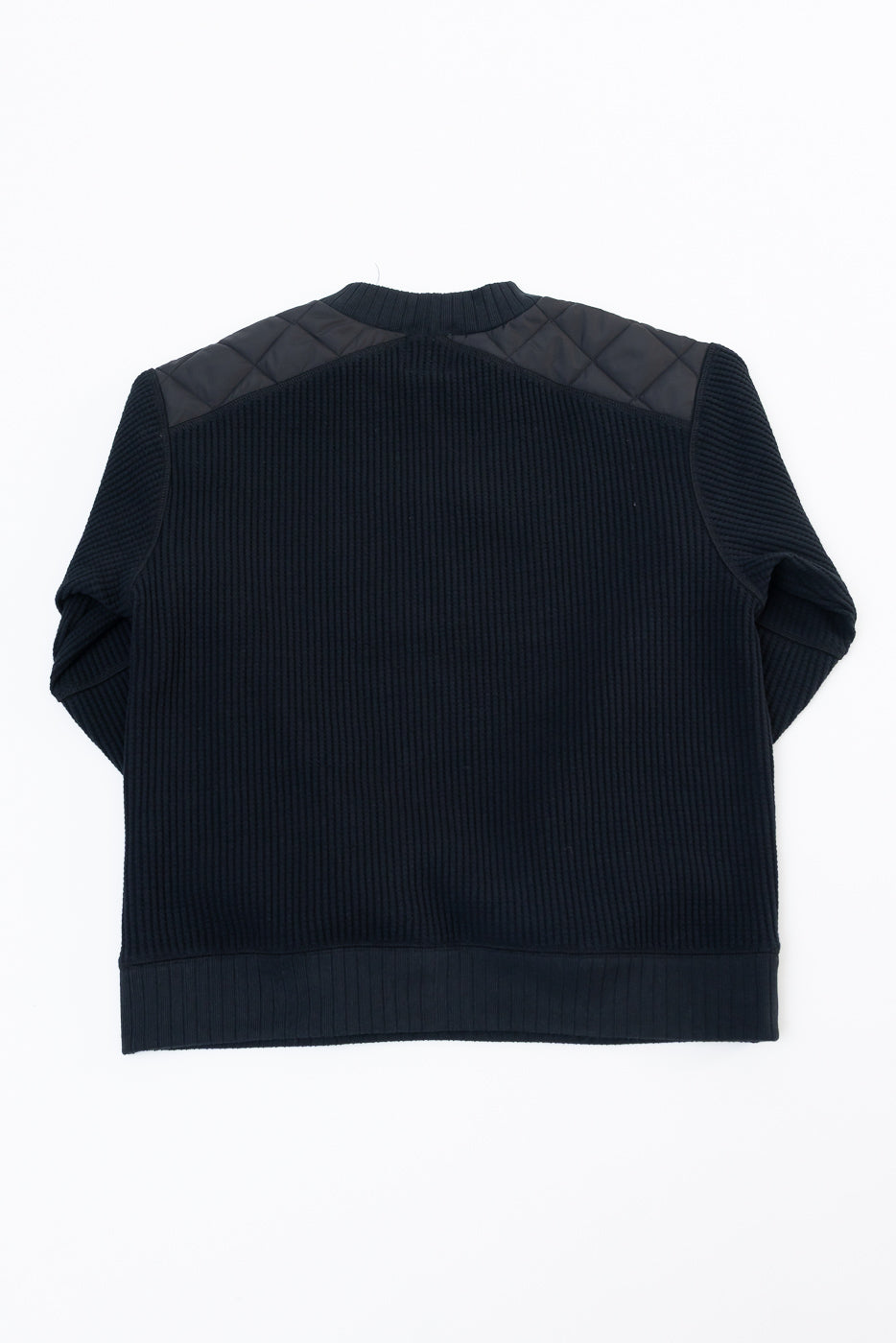 Flat lay back view of a black ribbed knit sweater featuring quilted shoulder patches.