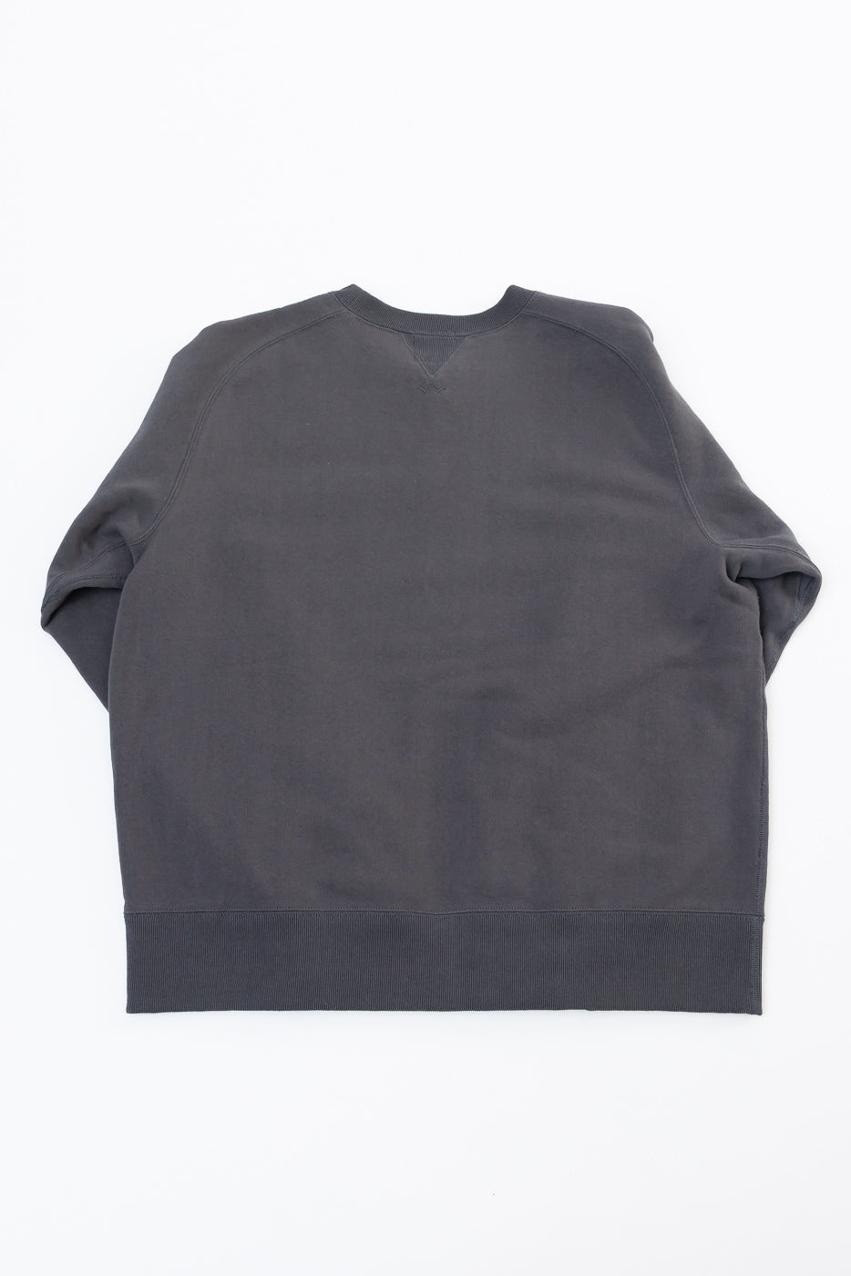 Flat lay of the back of a charcoal grey crewneck sweatshirt.