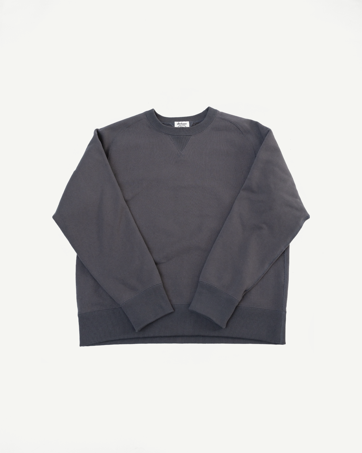 Front view flat lay of a charcoal grey crewneck sweatshirt with ribbed cuffs and hem.