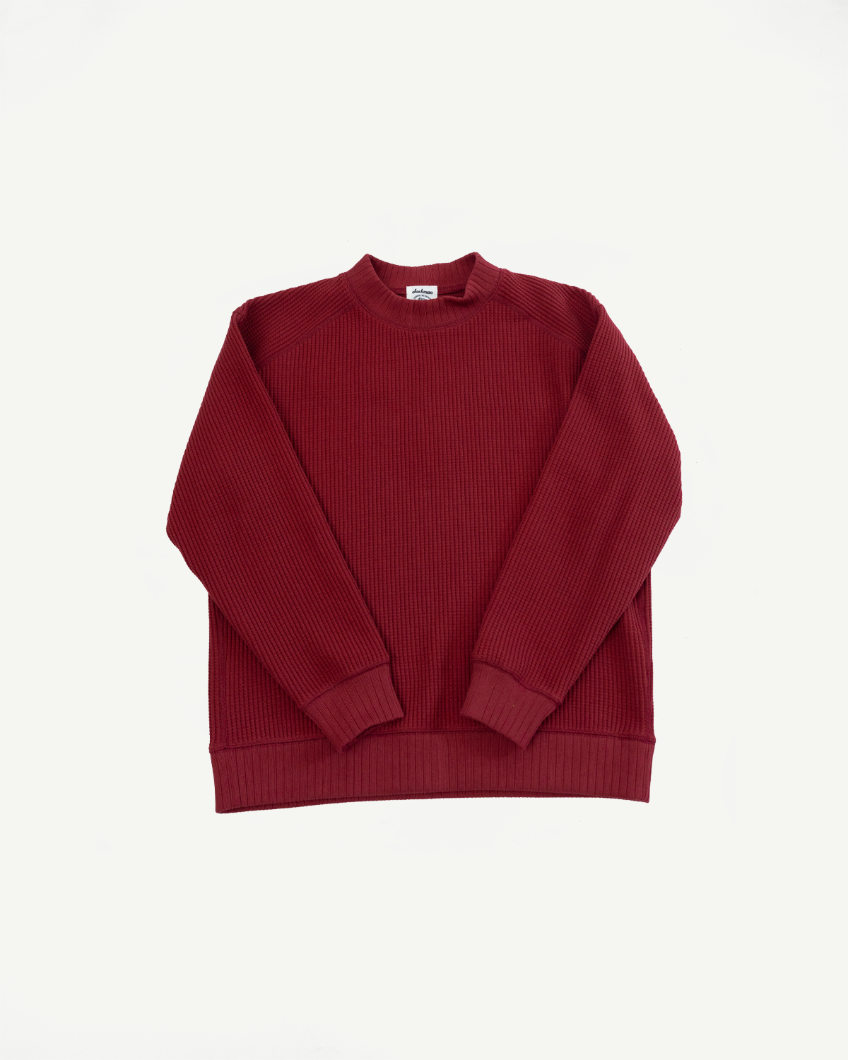 Flat lay front view of a maroon ribbed crewneck sweatshirt with ribbed cuffs and hem.