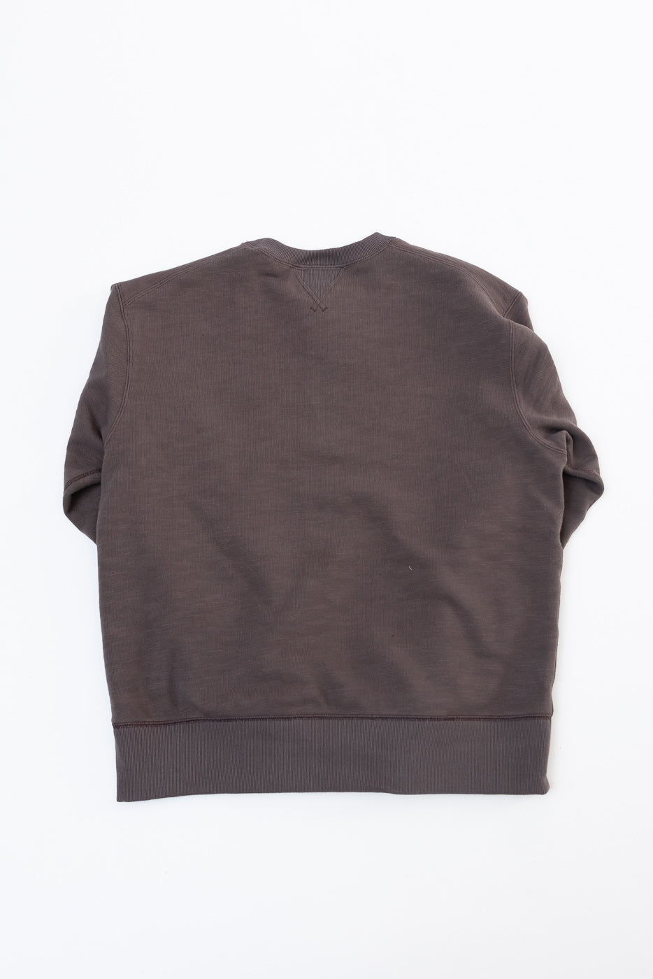 Back view flat lay of a dark brown crewneck sweatshirt showing the hem and shoulder seams.