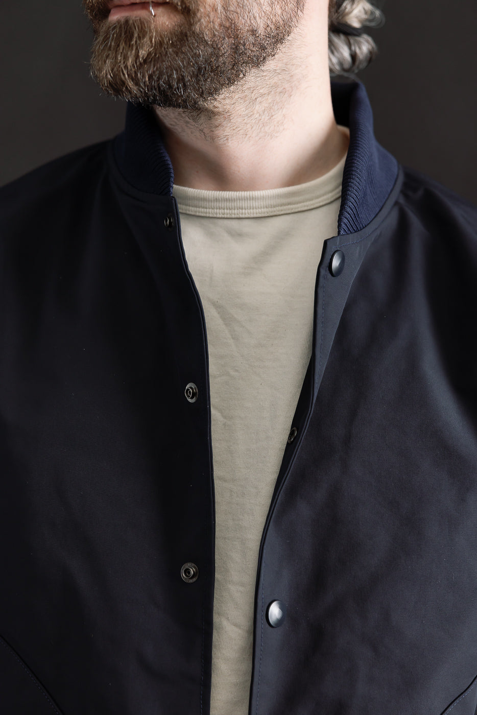 Close-up front view of dark navy oxford award jacket, male model 5'9