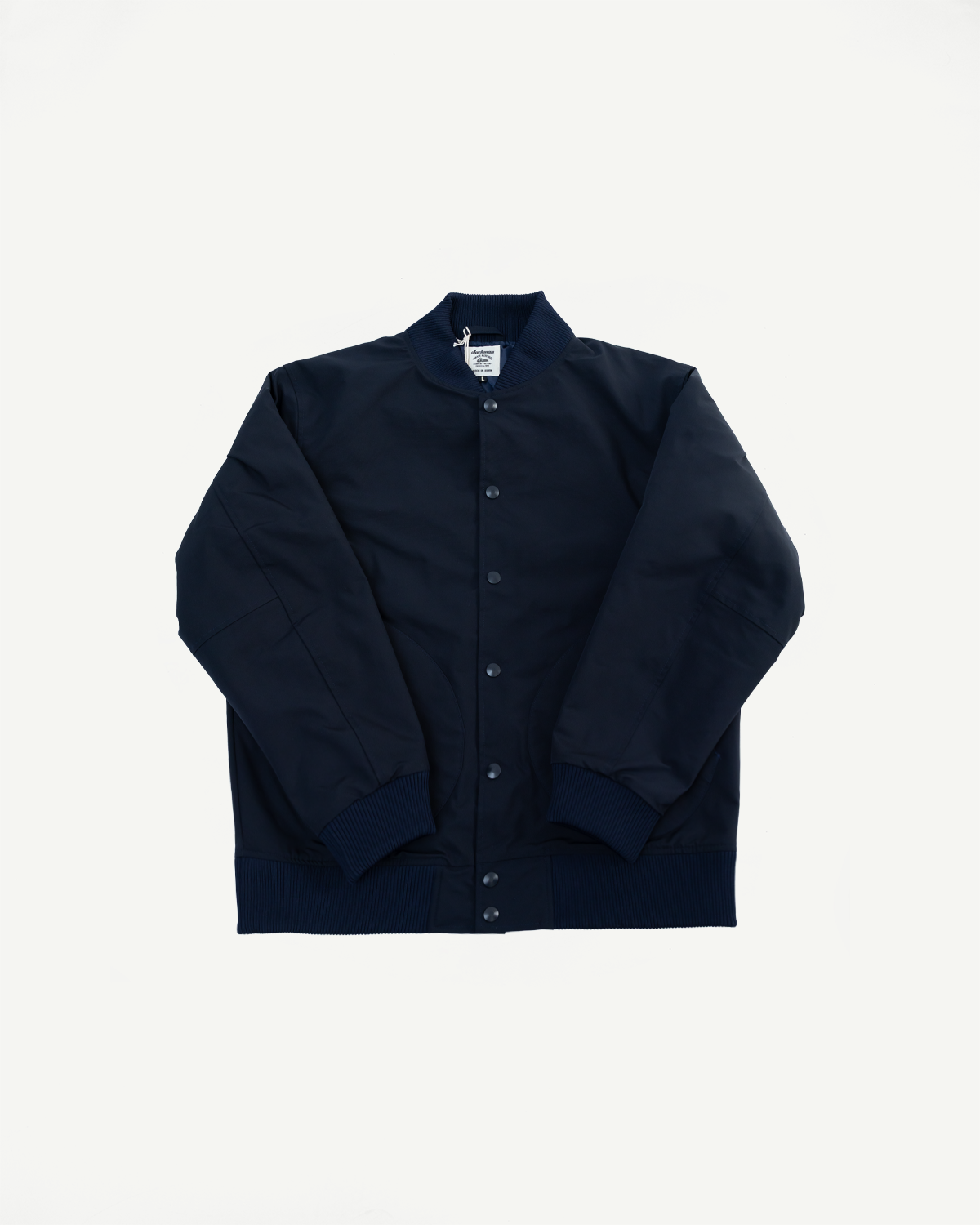 Flat lay front view of dark navy men's award jacket, snap buttons, ribbed collar, cuffs, and hem.