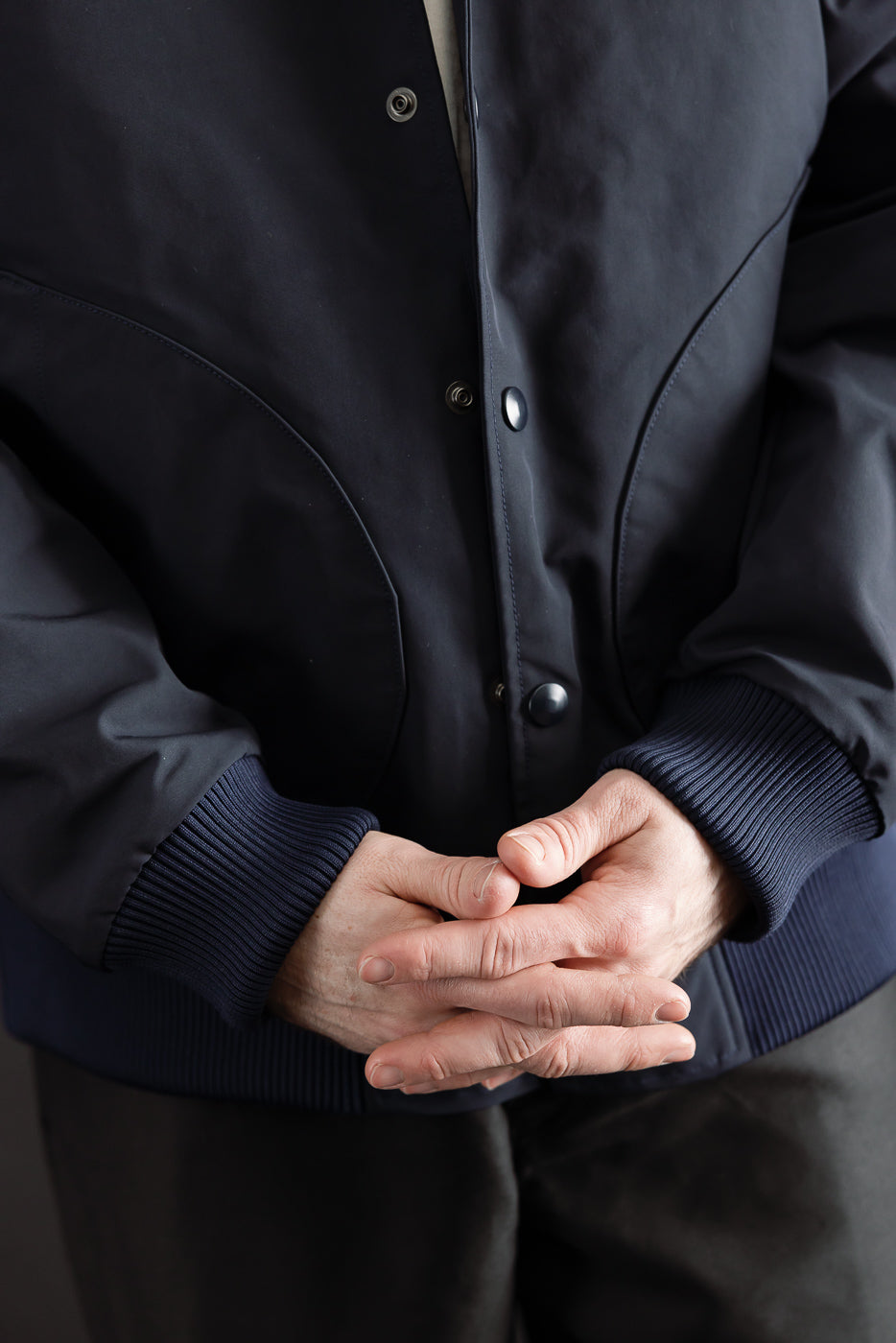 Close-up front view of dark navy award jacket on male model 5'9