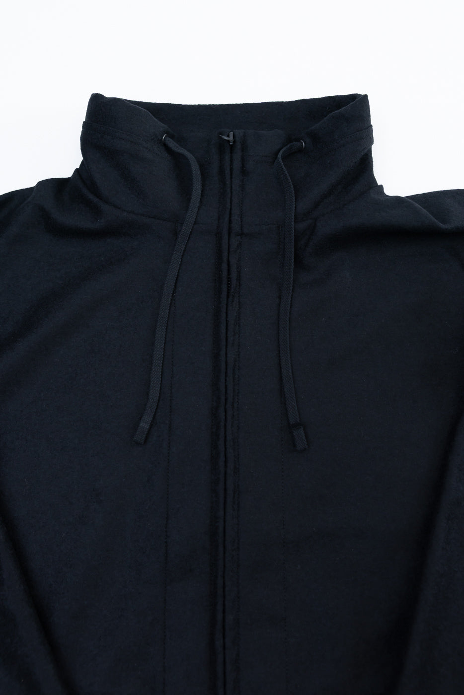Close-up front view of black wool stand neck jacket showing collar, drawstrings, and fabric texture.