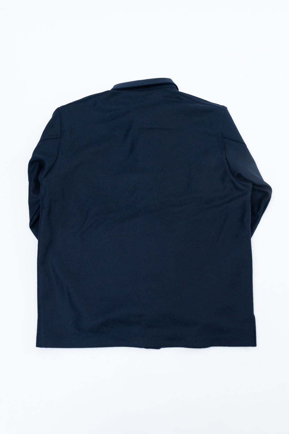 Flat lay of navy wool blend shirt, back view, showing straight hem and long sleeves.