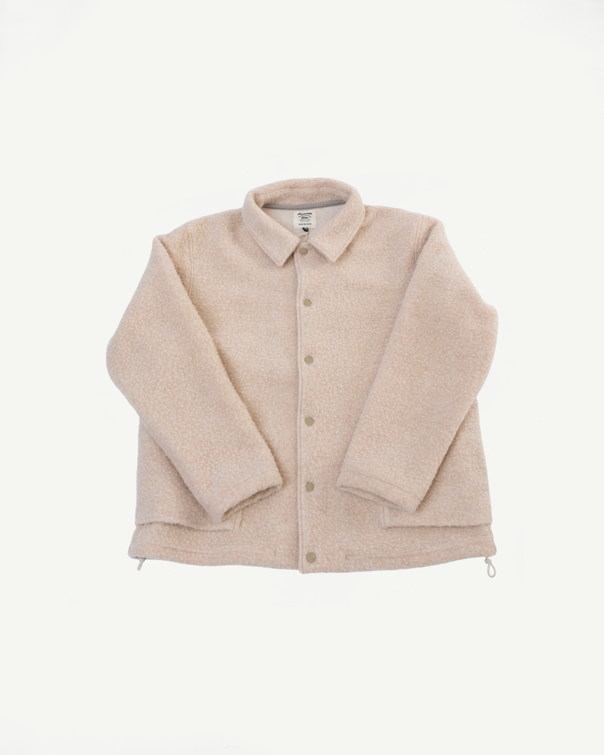 Front view flat lay of a beige textured fleece jacket with button closure and drawstring hem.