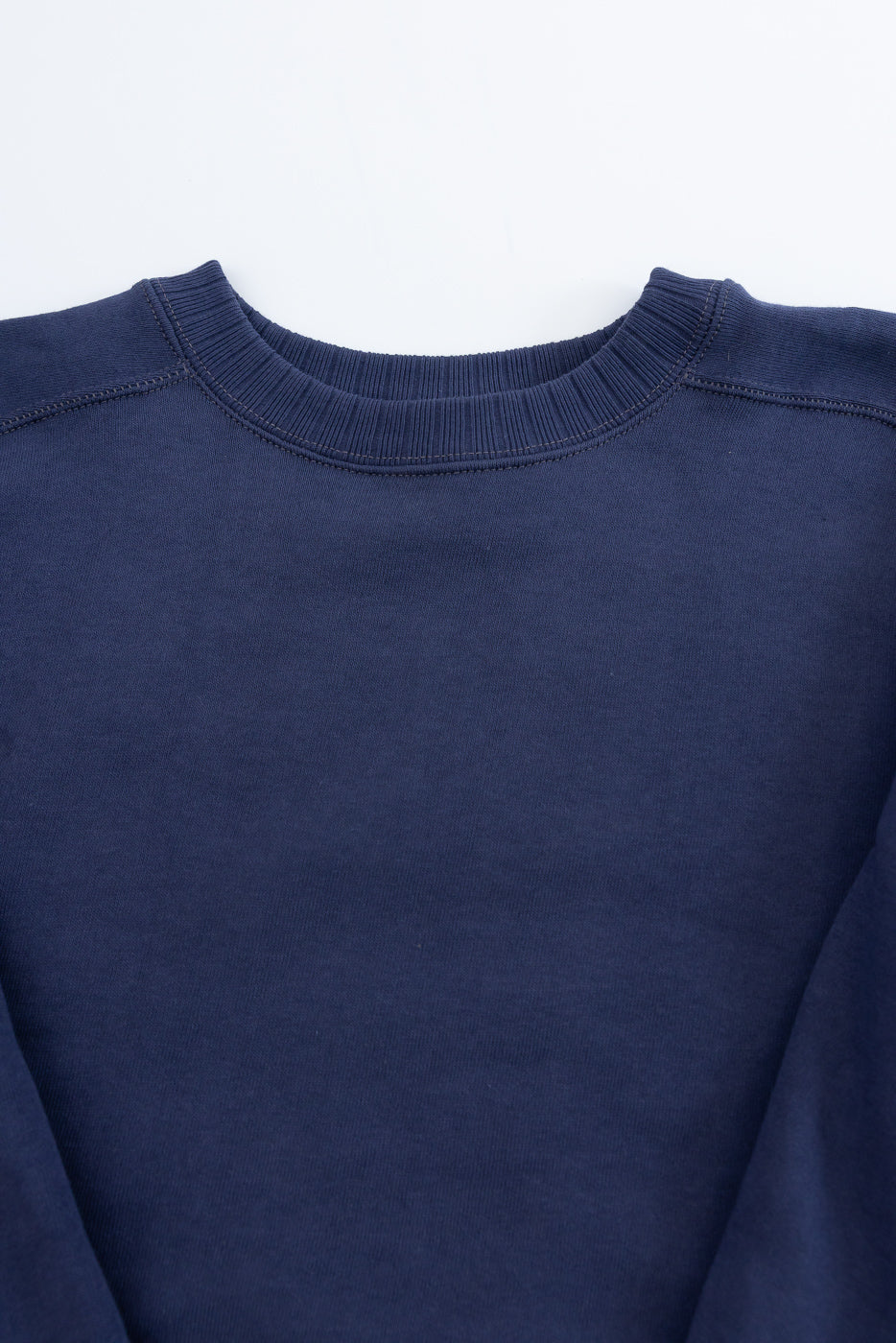 Navy crewneck of the JG-CS24 Albert Sweat, showcasing ribbed collar and shoulders, is inspired by Albert Einstein's Princeton sweatshirt, crafted from 100% cotton with freedom sleeve construction for a relaxed fit.