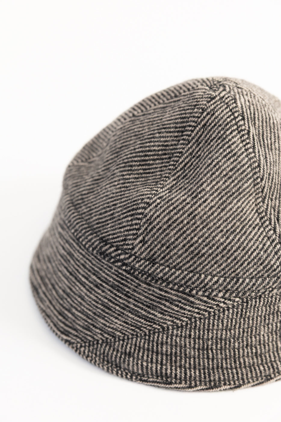 Close-up of John Gluckow Lot JG-31 beige tweedy prison cap, rear side, showing fabric texture and stitching details.