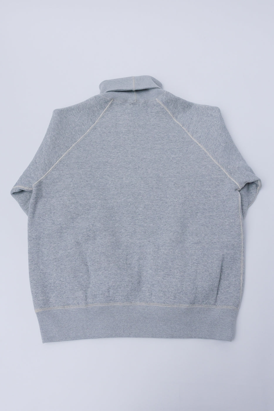 Flat lay of Loop & Weft super fluffy knit raglan turtleneck, back view, vintage melange grey