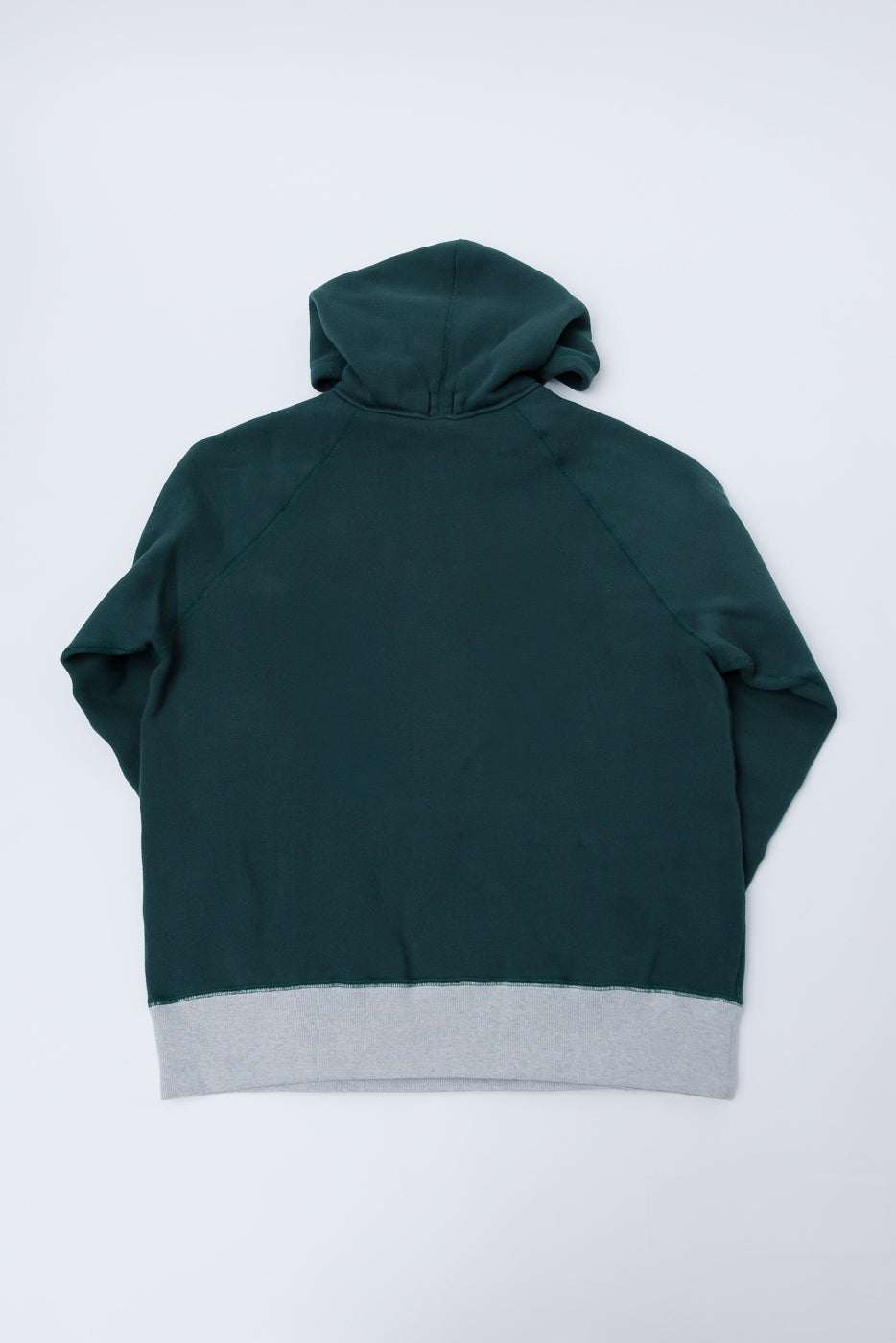 Flat lay of Loop & Weft Super Fluffy Knit Raglan Hoodie, back view, forest green with grey hem