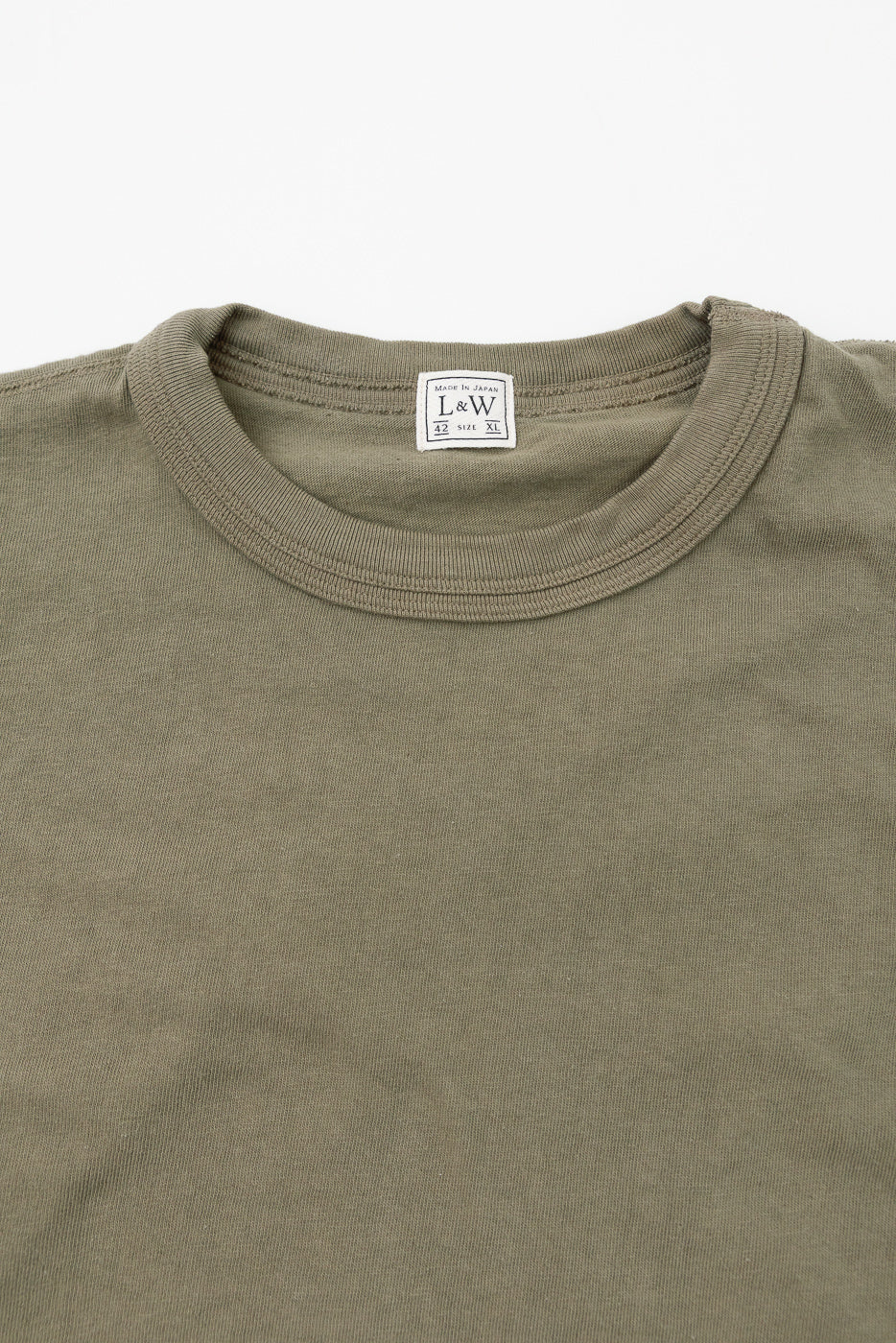 Close-up of olive green tee's collar, showing L&W tag, size XL, made in Japan