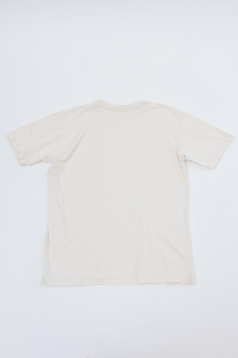 Back view flat lay of off-white crew neck t-shirt, showing clean hem and relaxed fit