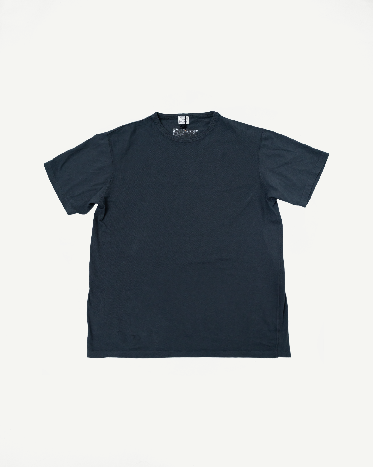 Dark navy men's crew neck t-shirt flat lay, front view, showing tag detail and ribbed collar.