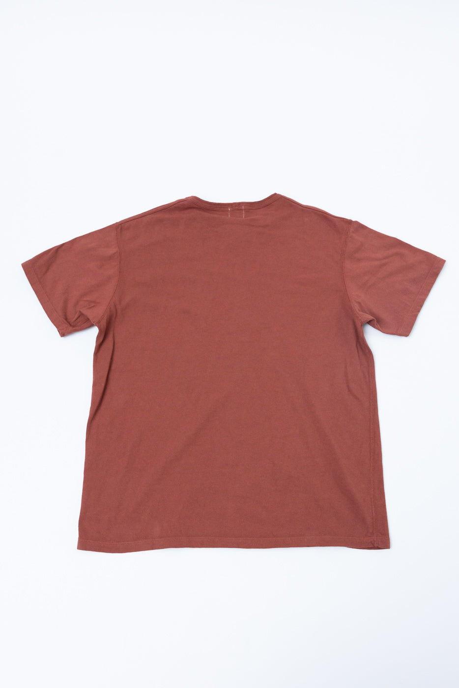 Flat lay back view of rust-colored short sleeve t-shirt, showing crew neck and hem details