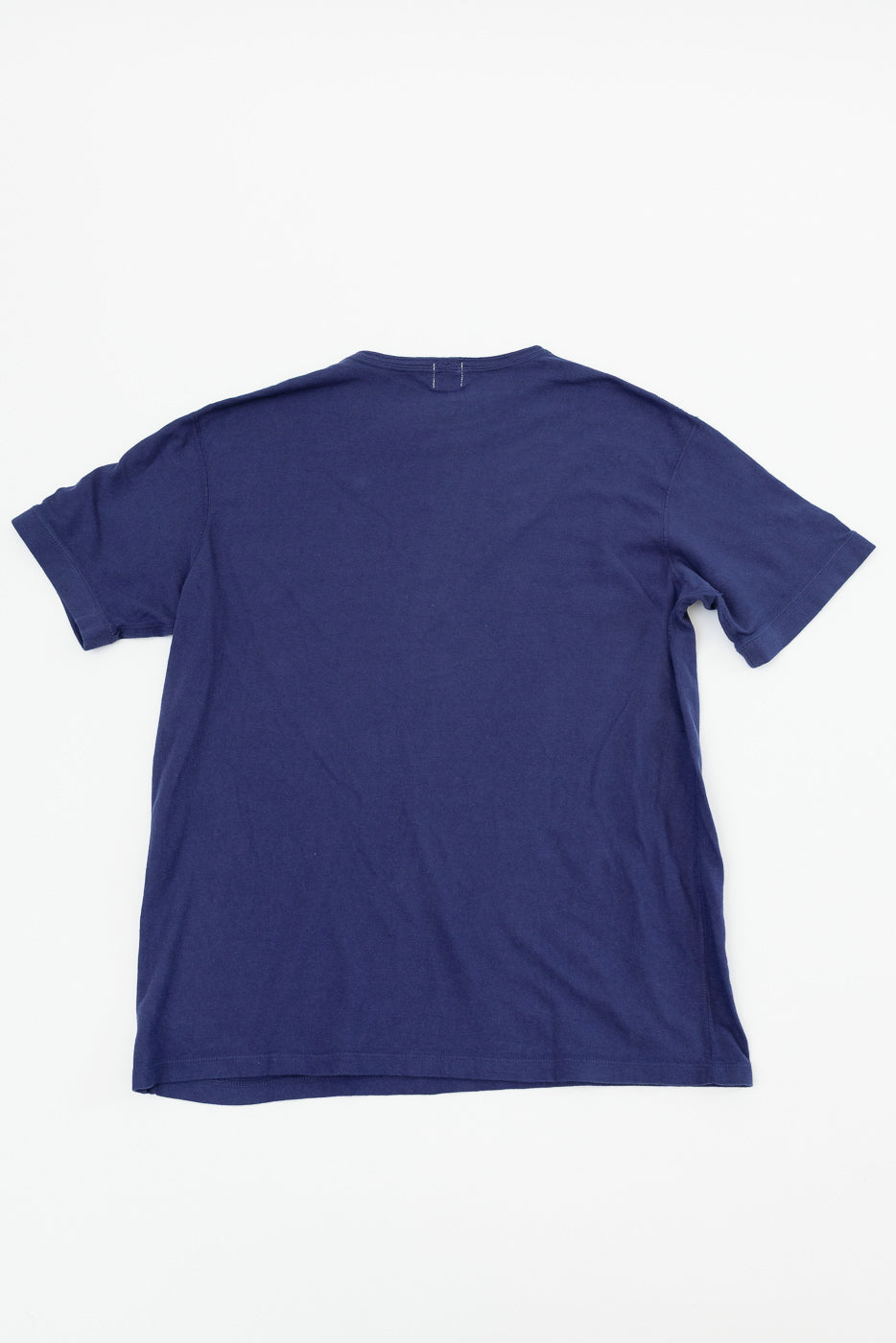 Back view of navy blue t-shirt, flat lay, showcasing hem and shoulder seams