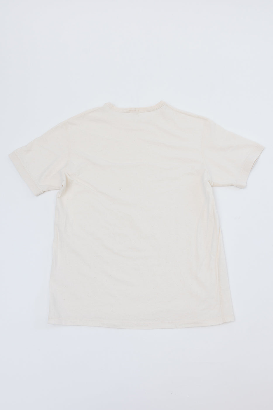Back view flat lay of off-white short sleeve t-shirt, showing crew neck and hem details
