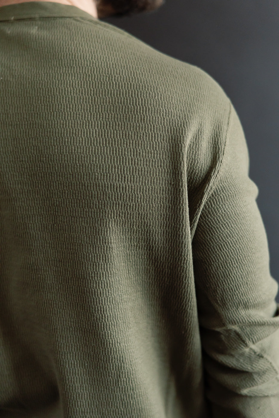 Close-up back view of army olive Supima honeycomb knit thermal Henley on male model, highlighting textured fabric.