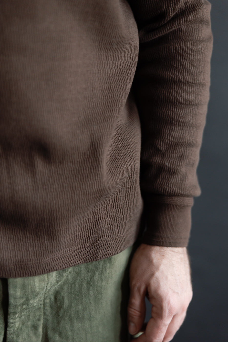 Close-up front of men's oak brown Supima honeycomb knit thermal sleeve, athletic 5'9 165lb model