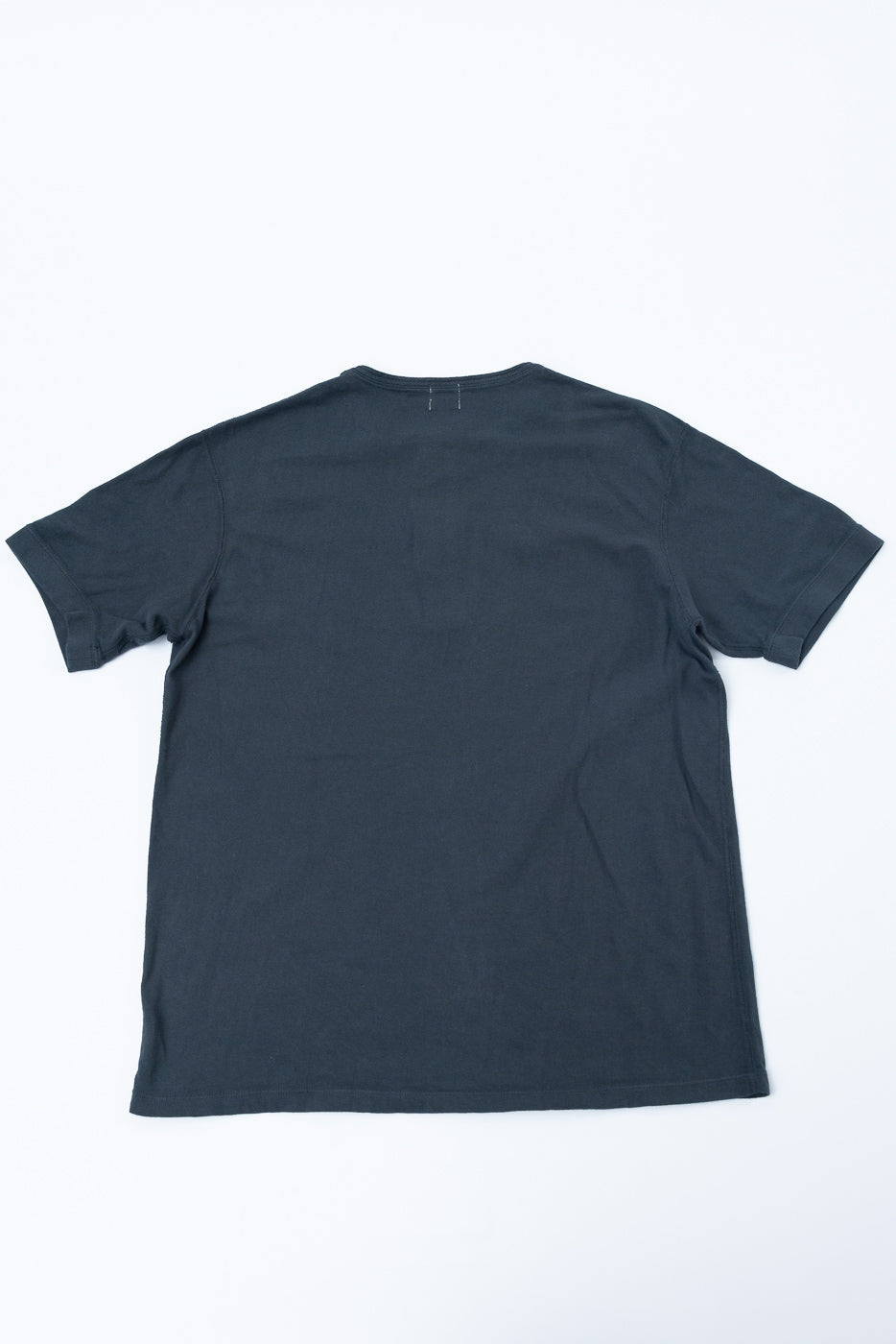 Back view of dark gray men's t-shirt, flat lay, showcasing hem and sleeve details
