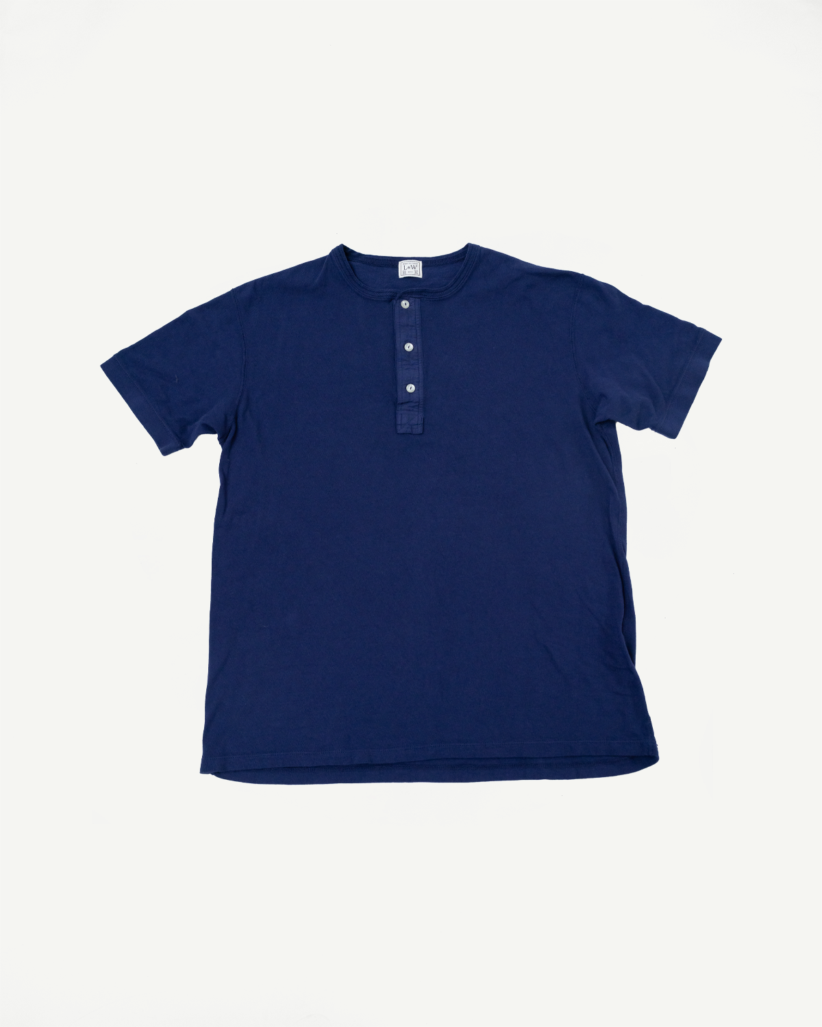 Navy blue henley tee, front flat lay, ribbed collar, 3-button placket, short sleeves, clean hem