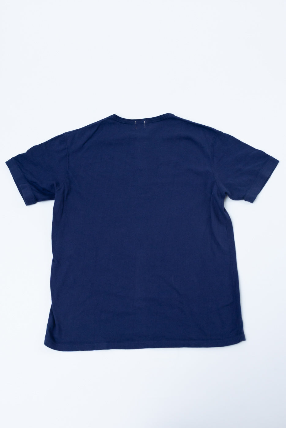 Navy blue crew neck t-shirt back view, flat lay, showing clean hem and shoulder seams