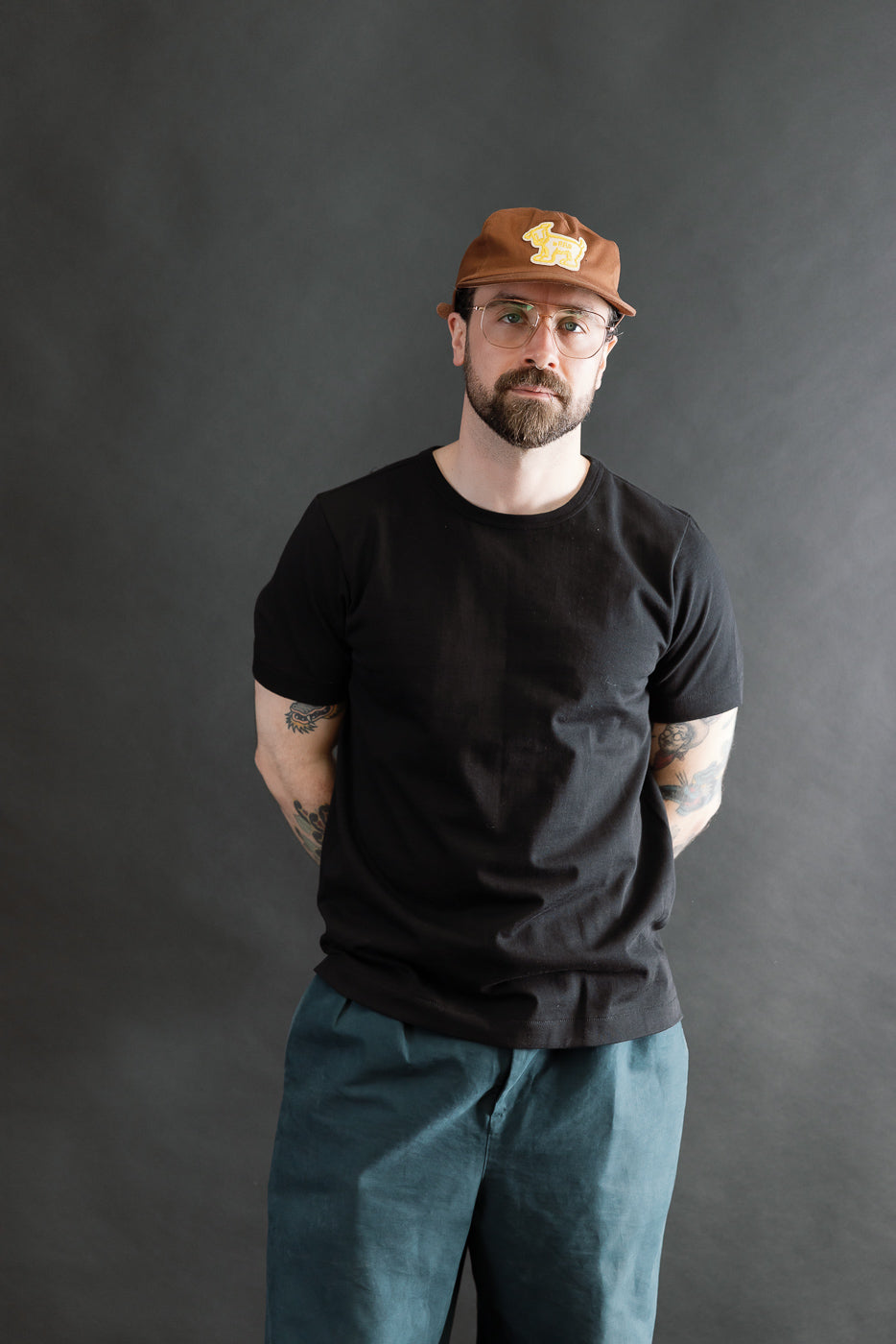 Man wearing the 215.99 - 7.2oz Loopwheeled T-Shirt Classic Fit in Deep Black, showcasing its classic fit and subtle loopwheel texture, embodying Dant's premium, heritage-inspired menswear ethos.
