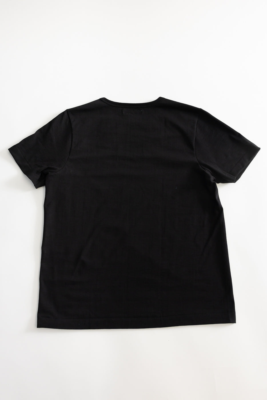Back view of the 215.99 - 7.2oz Loopwheeled T-Shirt Classic Fit - Deep Black, showcasing its plain design and subtle texture from loopwheel knitting, laid flat on a white background.