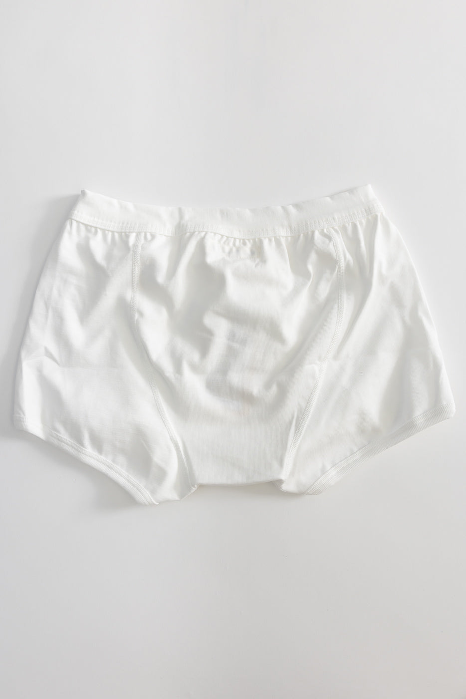 Flat lay of white loopwheeled boxer brief, front view, showing waistband and front panel details.
