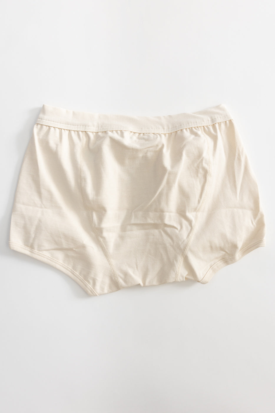 Light-beige cotton briefs, product title 254.02 - Loopwheeled Boxer Brief - Nature, laid flat; durable, full-coverage design from Merz, made with organic materials, reflecting Dant's heritage-inspired, high-quality menswear ethos.