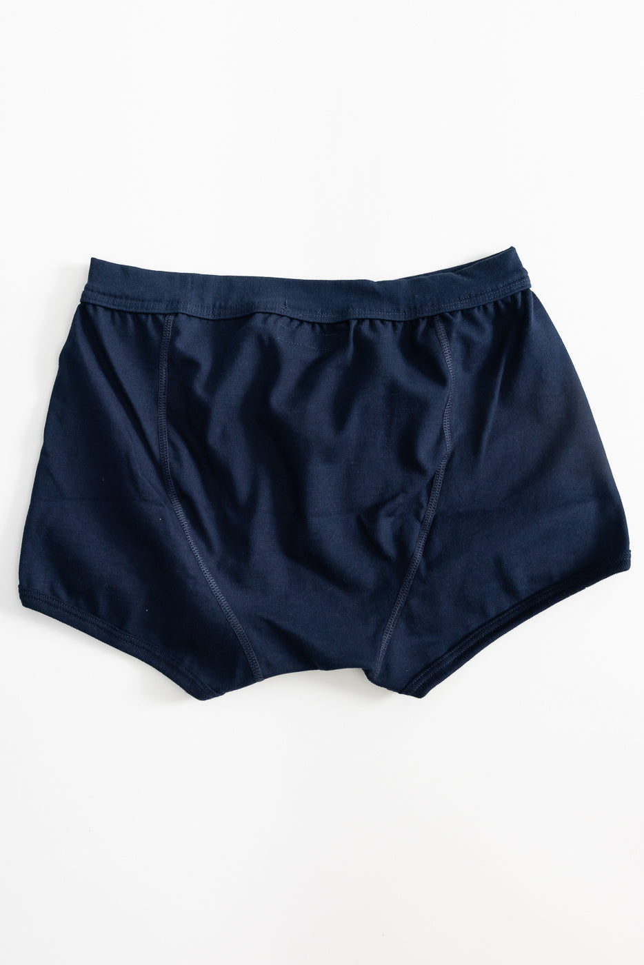 254.66 - Loopwheeled Boxer Brief - Ink Blue, showcasing a smooth, elastic knit from organic cotton. The boxer brief features a keyhole opening and elastic waistband, laid flat to highlight its premium craftsmanship.