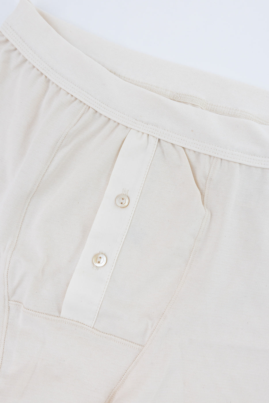 Close-up front view of loopwheeled boxer, button fly, showing fabric texture and buttons.