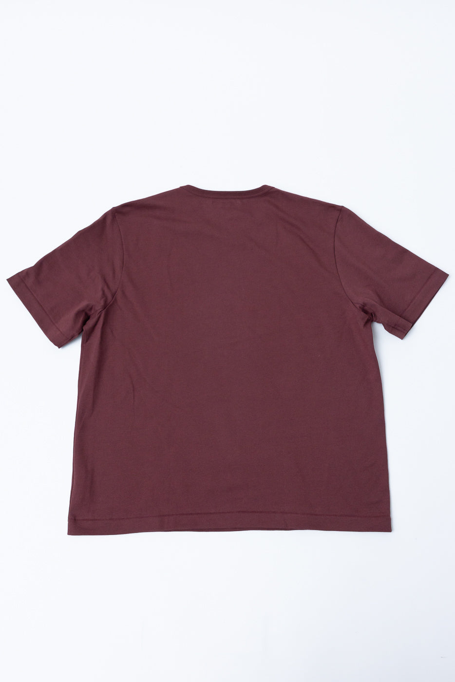 Flat lay view of the back of a burgundy short-sleeve t-shirt.