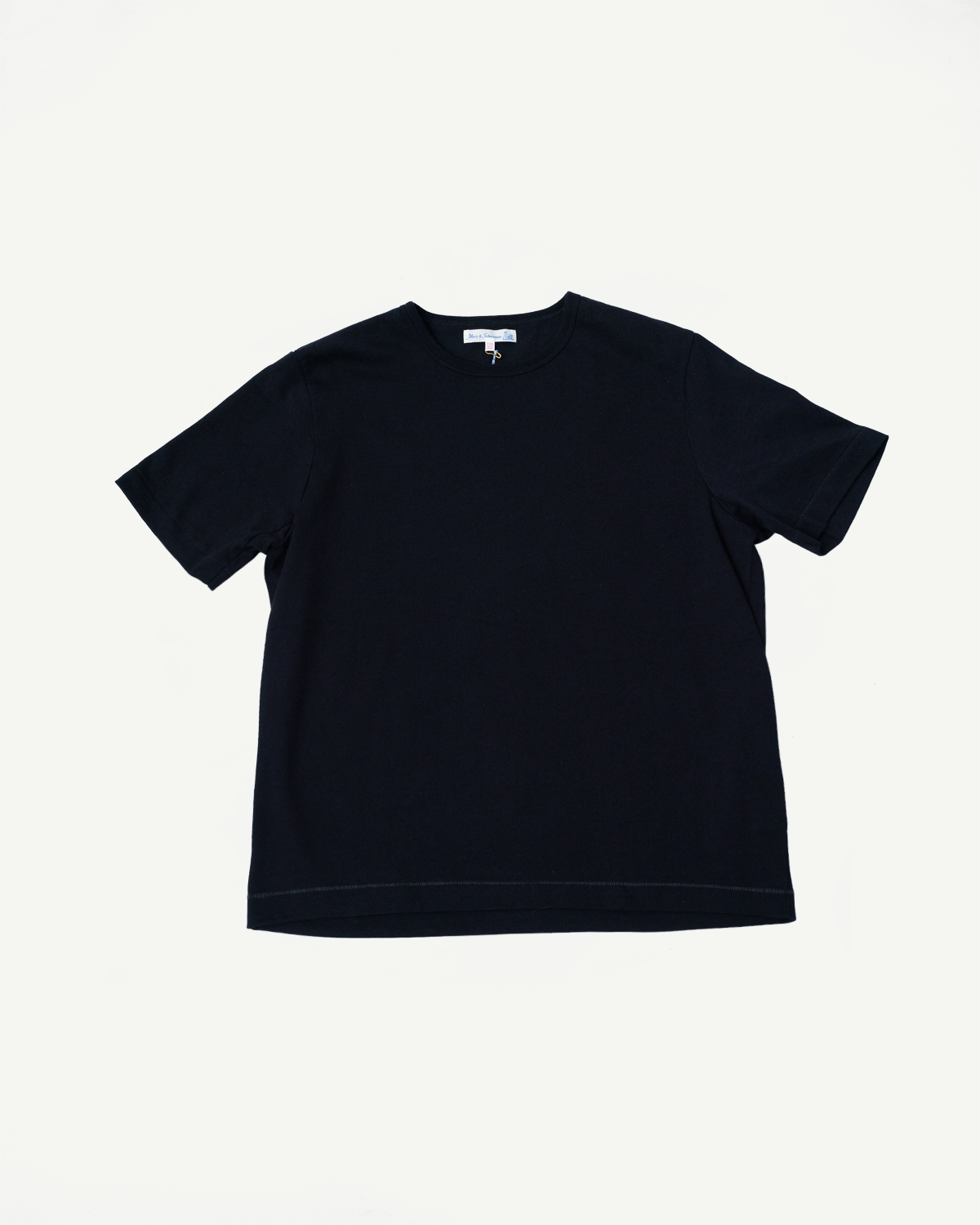Front view of a plain navy blue crew neck short sleeve t-shirt flat lay.