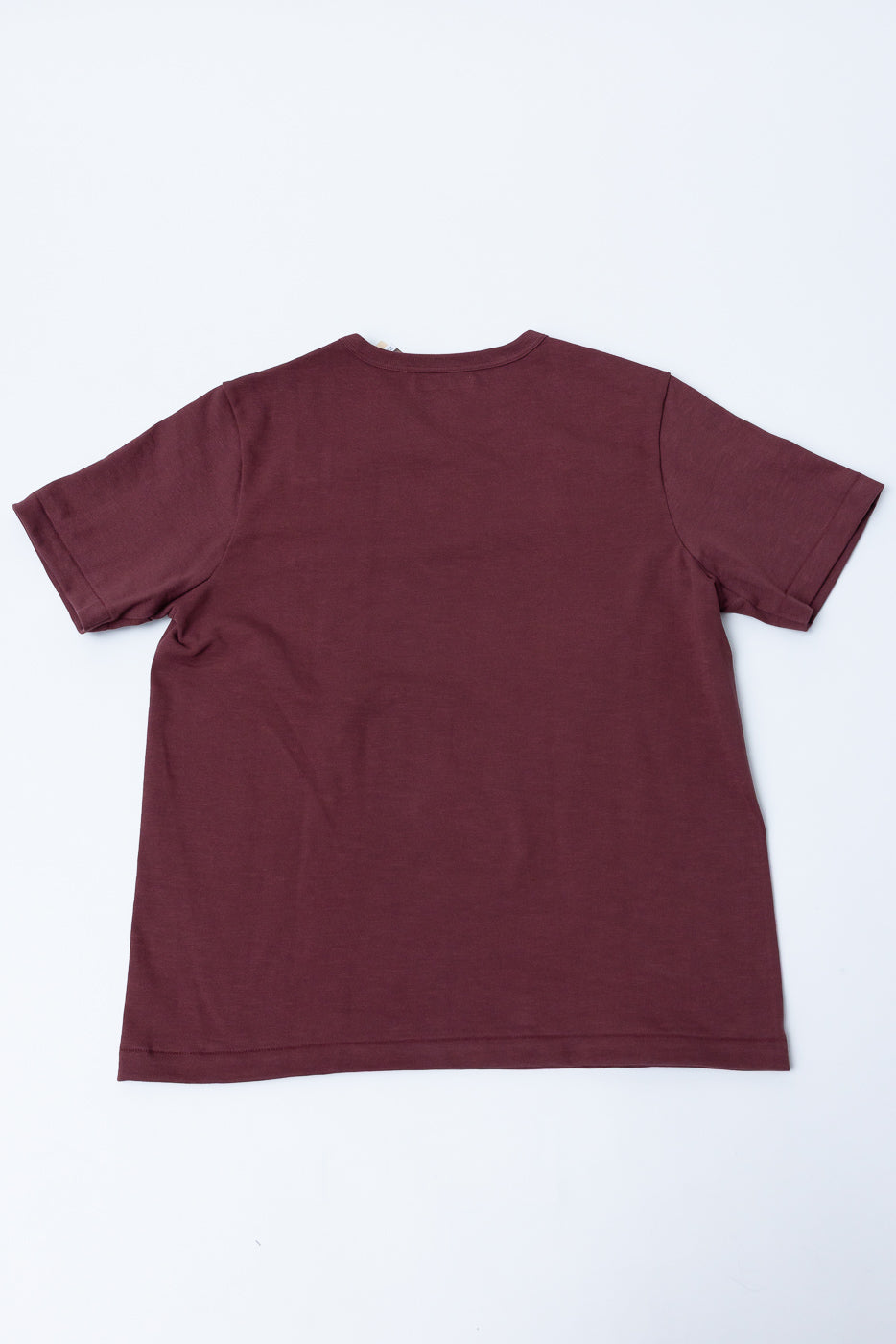 Flat lay, back view of a maroon crewneck t-shirt on a white background.