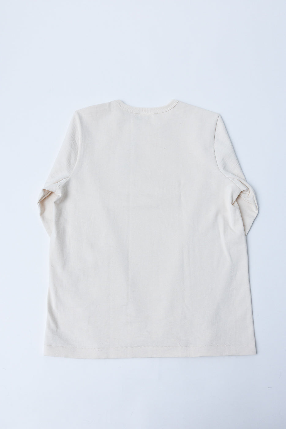 Flat lay, back view of a cream long-sleeve cotton t-shirt.