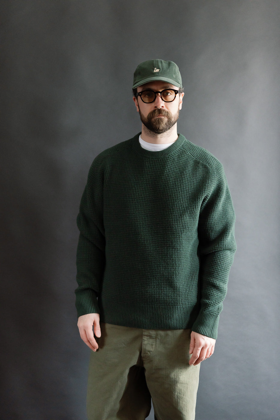 Male model, 5'9 165lbs athletic build, front view wearing bottle green merino wool cashmere waffle pullover, relaxed fit, at Dant store.